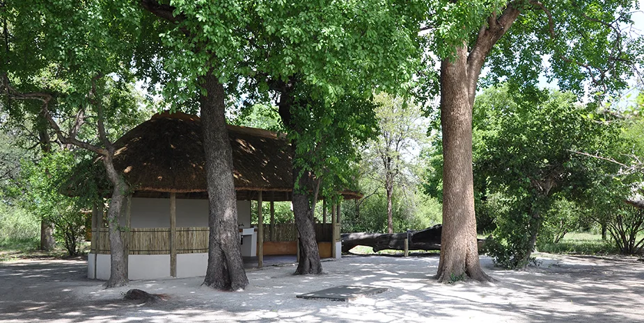 A private campsite’s thatched lapa beneath mature trees